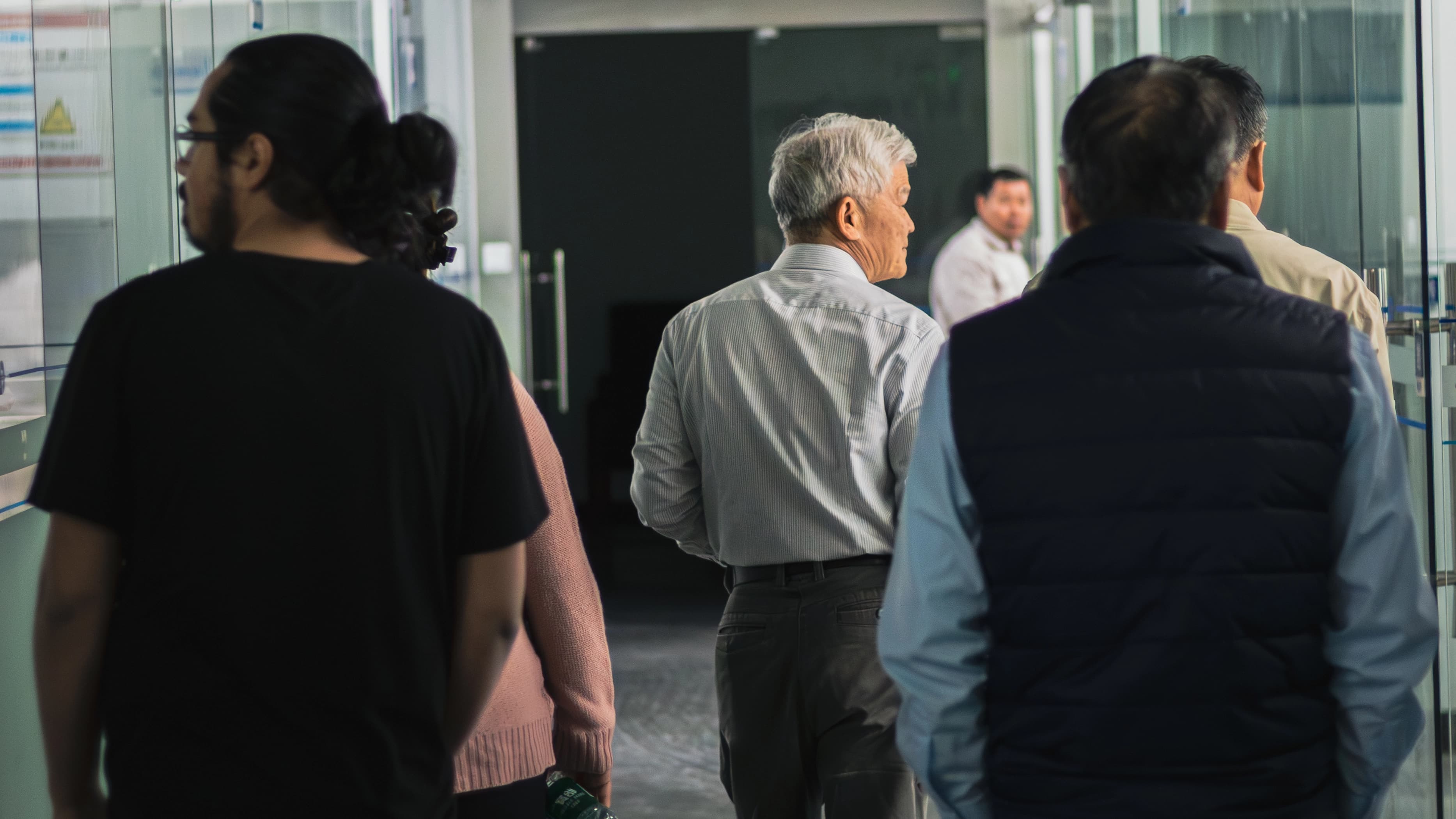 Group walking through factory hallway