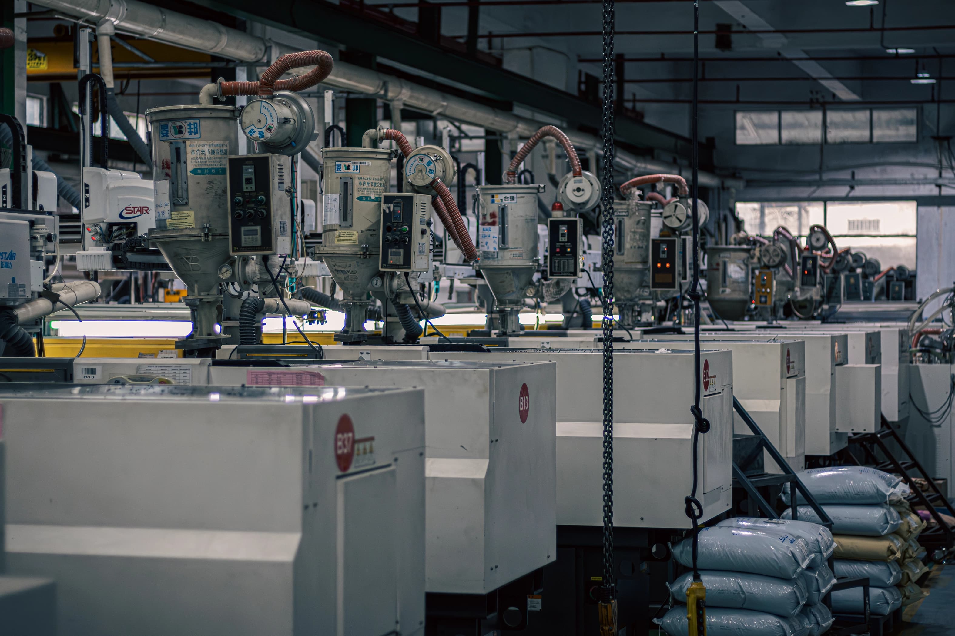 Row of injection molding machines on factory floor