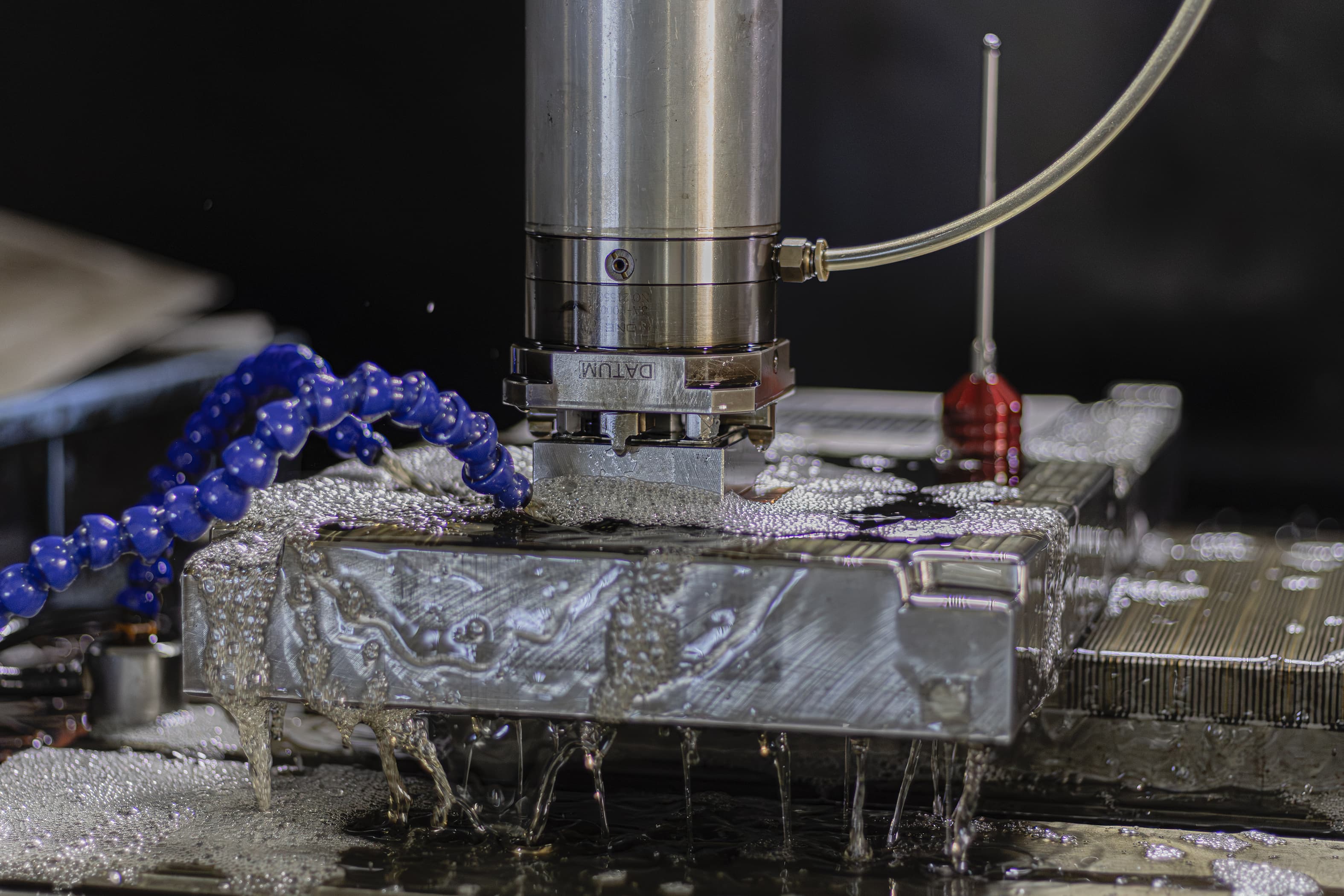 CNC milling machine with coolant spray during operation